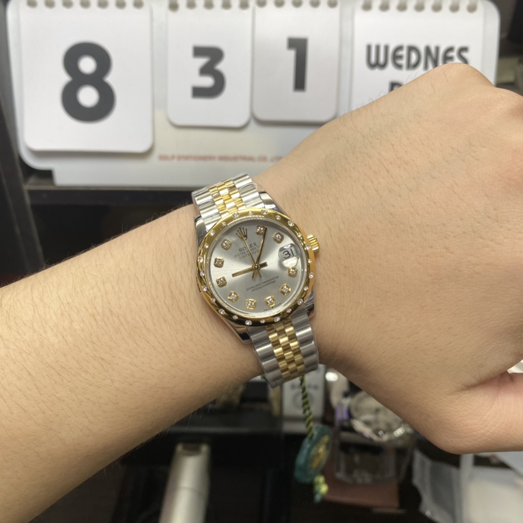 Rolex Datejust Series 178343-63163, Two-Tone Gold Case Silver Dial with Diamond Hour Markers Round Arched Bezel Set with Diamonds, 31mm Size, Five-Link Steel Bracelet.